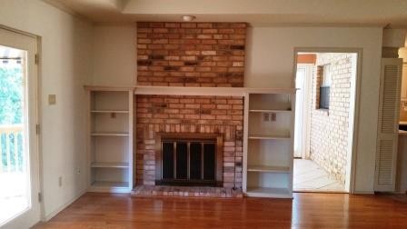 woodburning fireplace with built in bookshelves